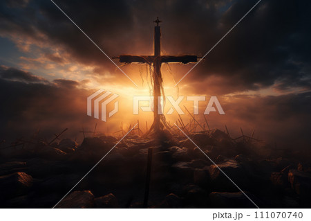 Silhouette of a cross on a hill in the rays of the setting sun. 111070740