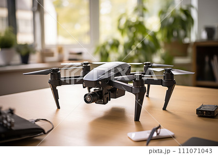 Modern drone with a video camera on a wooden table. 111071043