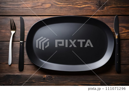AI-generated content. Empty black rectangular plate, knife and fork on brown rustic wooden 111071296