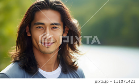 Elegant handsome smiling young Asian man wih long hair, on light blue, banner, copy space, portrait. Elegant handsome smiling young Asian man wih long hair, on light blue, banner, copy space, portrait. 111071423