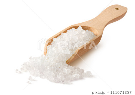 Salt crystals in a wooden scoop isolated on white background Salt crystals in a wooden scoop isolated on white background 111071857