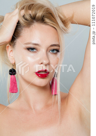 Glamorous blonde woman with fashion jewelry eraring, blond hairstyle, clean fresh skin 111072019