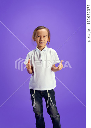 Happy, smiling little boy showing thumb up, like sign against purple background. Human positive emotions. Celebration national holidays. 111072375