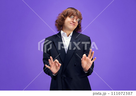 Portrait f charismatic man looks at camera and expressed that everything will be fine looking at camera and gesturing Ok sign. Portrait f charismatic man looks at camera and expressed that everything will be fine looking at camera and gesturing Ok sign. 111072387