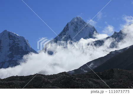 Mount Cholatse surrounded by autumn fog. View from Gorakshep, Nepal. Mount Cholatse surrounded by autumn fog. View from Gorakshep, Nepal. 111073775