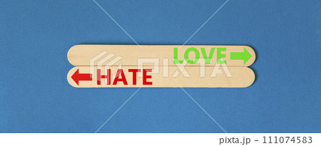 Love or hate symbol. Concept word Love or Hate on beautiful wooden stick. Beautiful blue table blue background. Business and love or hate concept. Copy space. 111074583
