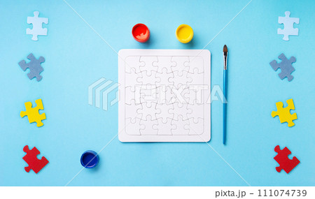 World Autism Awareness Day Card, colorful Puzzles on Blue Background. World Autism Awareness Day Card, colorful Puzzles on Blue Background. 111074739