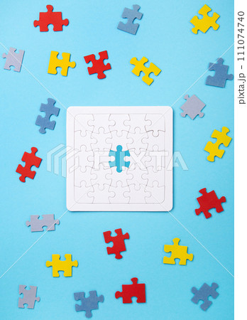 Autistic Pride Day. World Autism Awareness Day Concept, colorful Puzzles on Blue Background. Autistic Pride Day. World Autism Awareness Day Concept, colorful Puzzles on Blue Background. 111074740