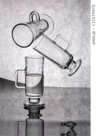 Still life with glassware on a reflective surface 111074978