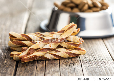 Dog food. Snack sticks for dogs on wooden table. 111075227