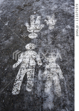 Ice covered sidewalk with a pedestrian path sign Ice covered sidewalk with a pedestrian path sign 111075979