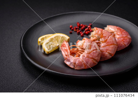 Delicious shrimp or langoustine tails boiled with salt and spices 111076434