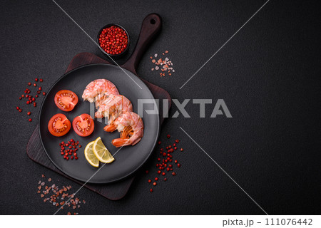 Delicious shrimp or langoustine tails boiled with salt and spices 111076442