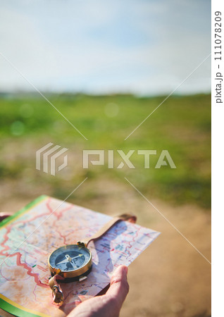 Close-up of a persons hand holding a compass - stock photography concepts 111078209