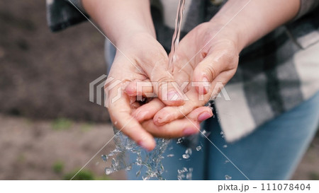 caring cleanlines hands, concept agriculture, concept fresh clean water, refreshing splashes fly different directions, wash your fingers, problem water environment, ecology, cleaning skin from dirt 111078404