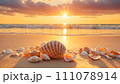 Ocean sunset: seashells on sandy shore 111078914