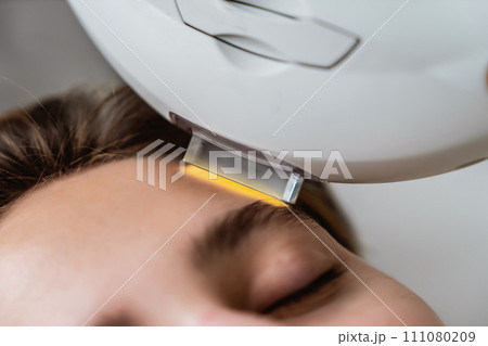 Phototherapy, photorejuvenation, IPL in a beauty salon. Care for a woman's face. 111080209