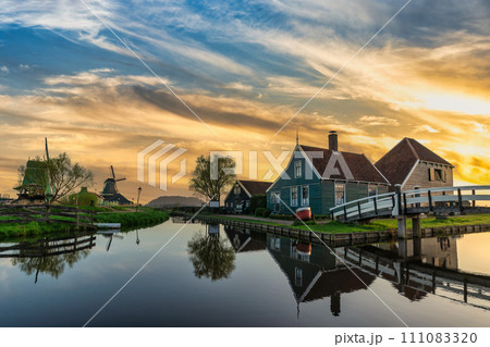 Sunrise at Zaanse Schans village with Dutch Windmill near Amsterdam Netherlands 111083320