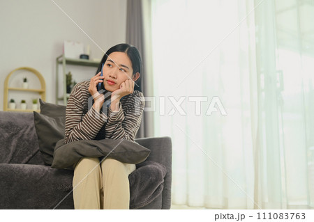 Thoughtful young woman talking on mobile phone and looking away, thinking of problem solution, considering idea 111083763