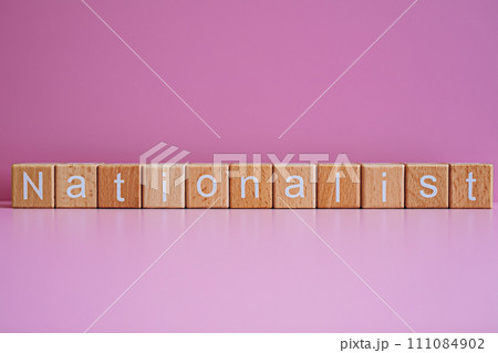 Wooden blocks form the text "Nationalist" against a pink background. 111084902
