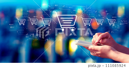 Online shopping theme with person using a smartphone at night 111085924