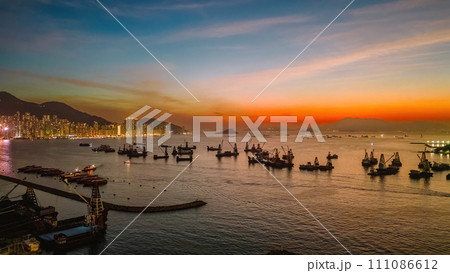 Sunset over the City Skyline with Ocean Reflections Dec 25 2023 111086612