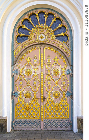 A gilded door decorated with exquisite carvings, the entrance to one of the boundaries of the Pochaev Lavra. View Pochaev Lavra to Pochaev, a city in western Ukraine. A gilded door decorated with exquisite carvings, the entrance to one of the boundaries of the Pochaev Lavra. View Pochaev Lavra to Pochaev, a city in western Ukraine. 111088659