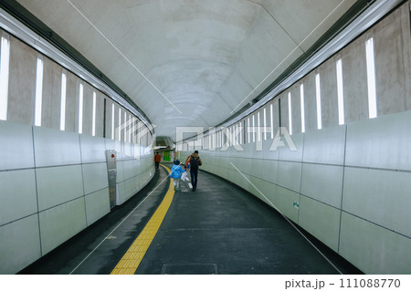 Nov 26 2023 Modern city subway station with commuters on the platform. Nov 26 2023 Modern city subway station with commuters on the platform. 111088770