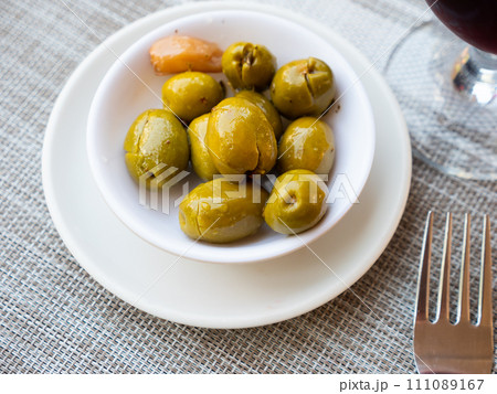 Light snack - few of pickled green pitted olives and slice of bran bread Light snack - few of pickled green pitted olives and slice of bran bread 111089167