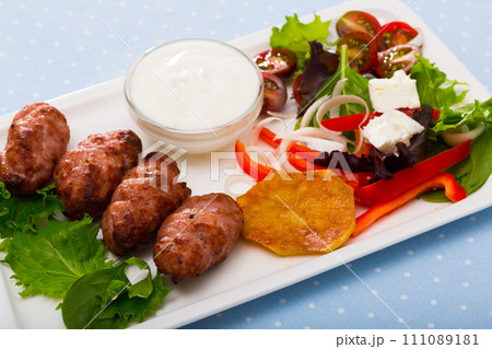 Cevapcici with green salad 111089181