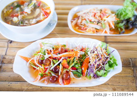spicy salad serve with grape and crab sticks,Thai food spicy salad serve with grape and crab sticks,Thai food 111089544