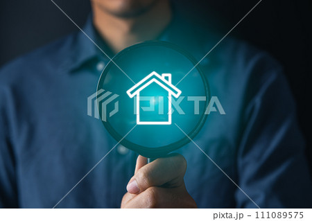 real estate investing concept.businessman using magnifier for searching and buying house 111089575