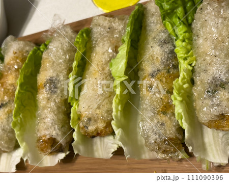 Asian nem dish on a bed of salad 111090396