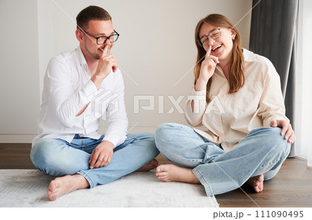Cute moment of dad and daughter fooling around. Young dad and kid joking and putting finger inside nose. Carefree girl and her father making funny faces to camera. 111090495