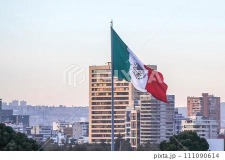 Mexico City, Mexico. Jan 11, 2024. On a winter afternoon in downtown Mexico City, a large Mexican flag gracefully flutters in the breeze. 111090614