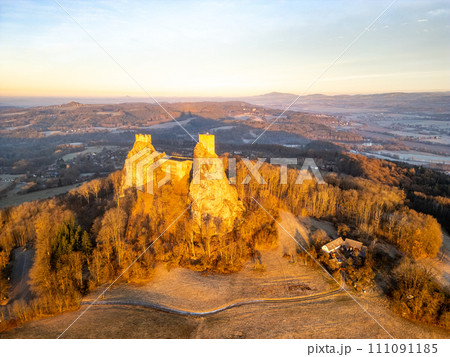 Trosky medieval castle ruins at cold morning sunrise time. Bohemian Paradise, Czech: Cesky raj, Czechia. Aerial view from above. 111091185