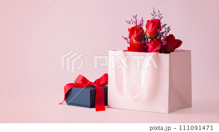 Pink gift bag with rose bouquet and black gift box on pink background, copy space Pink gift bag with rose bouquet and black gift box on pink background, copy space 111091471