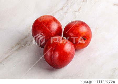 Ripe sweet juicy red plum 111092720