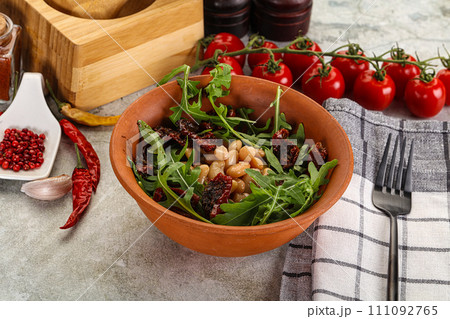 White canned beans with arugula and dry tomatoes White canned beans with arugula and dry tomatoes 111092765