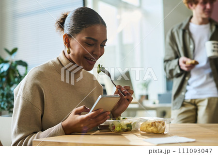 Watching online video and having salad 111093047