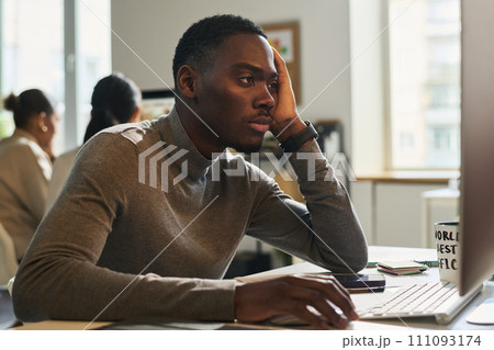 Young male manager doing boring work 111093174