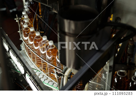 Bottles with fizzy lemonade on conveyor Bottles with fizzy lemonade on conveyor 111093283