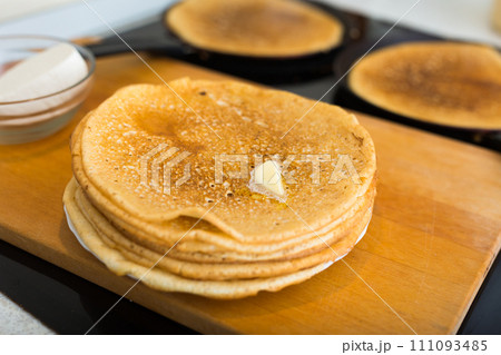 Stack of appetizing flour pancake in the kitchen during cooking Stack of appetizing flour pancake in the kitchen during cooking 111093485