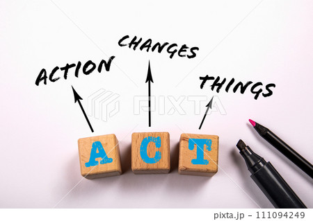 Action Changes Things. Wooden blocks on a white office table Action Changes Things. Wooden blocks on a white office table 111094249