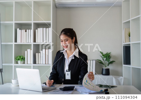 Business accounting woman counting on calculator working on financial document in hands closeup. Bookkeeping concept Business accounting woman counting on calculator working on financial document in hands closeup. Bookkeeping concept 111094304