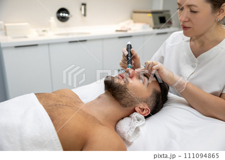 Man having cosmetological procedures in a beauty clinic 111094865