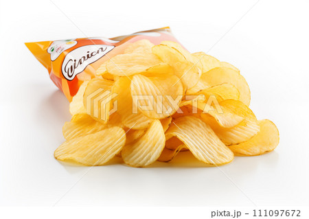 Opened packing of potato chips isolated on white background. Close up 111097672