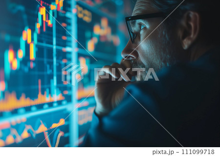 Expert analyst examining trading graphs 111099718
