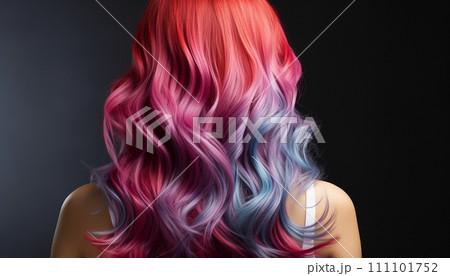 Vibrant cascade of multicolored hair, seamlessly transitioning from red to orange, purple, and teal, set against a dark backdrop Vibrant cascade of multicolored hair, seamlessly transitioning from red to orange, purple, and teal, set against a dark backdrop 111101752