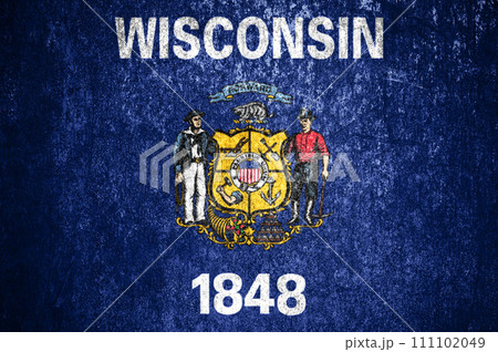 Close-up of the Wisconsin grunge flag. Dirty Wisconsin state flag on a metal surface. 111102049